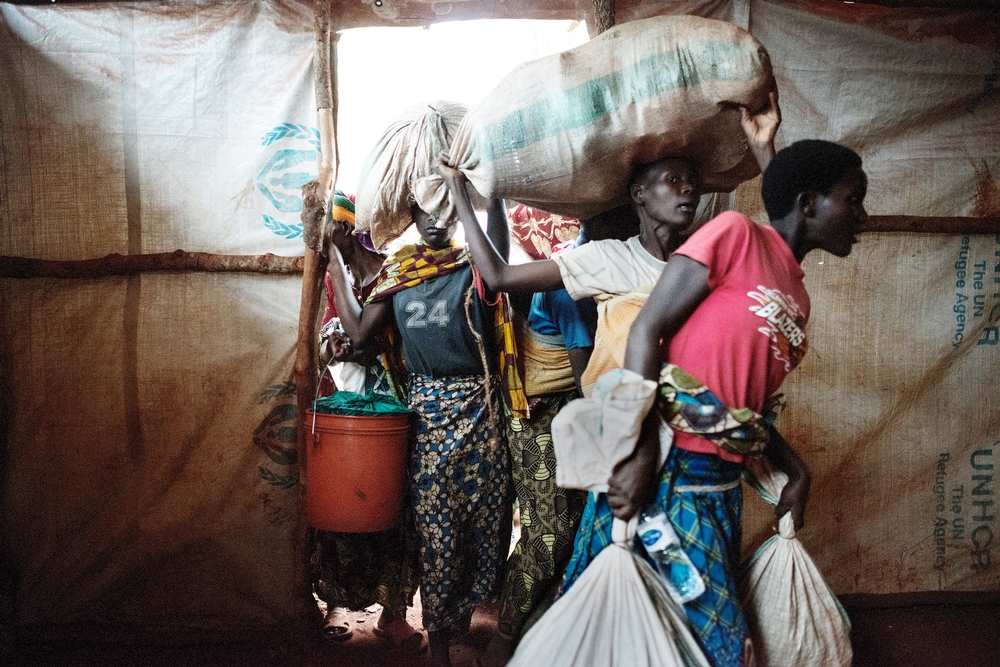 Newly arrived Burundian refugees enter the tent where they will stay in Nyarugusu, Tanzania.