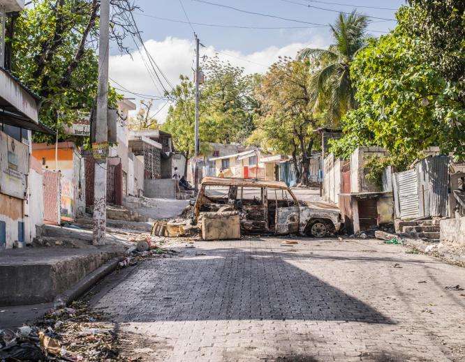 A destroyed car blocking a road in Port-au-Prince, Haiti.
