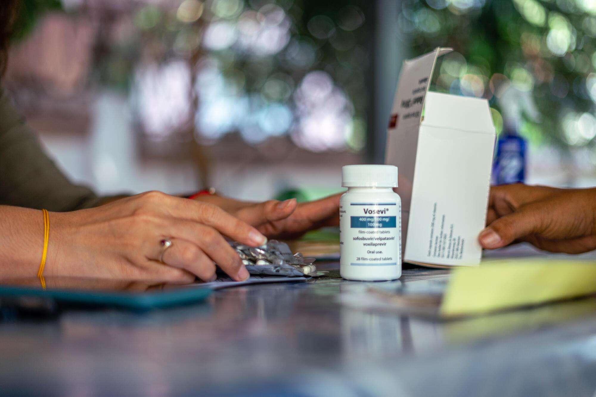 An MSF staff member prepares medication for a patient at an MSF office, in Yangon. Myanmar, April 2021.