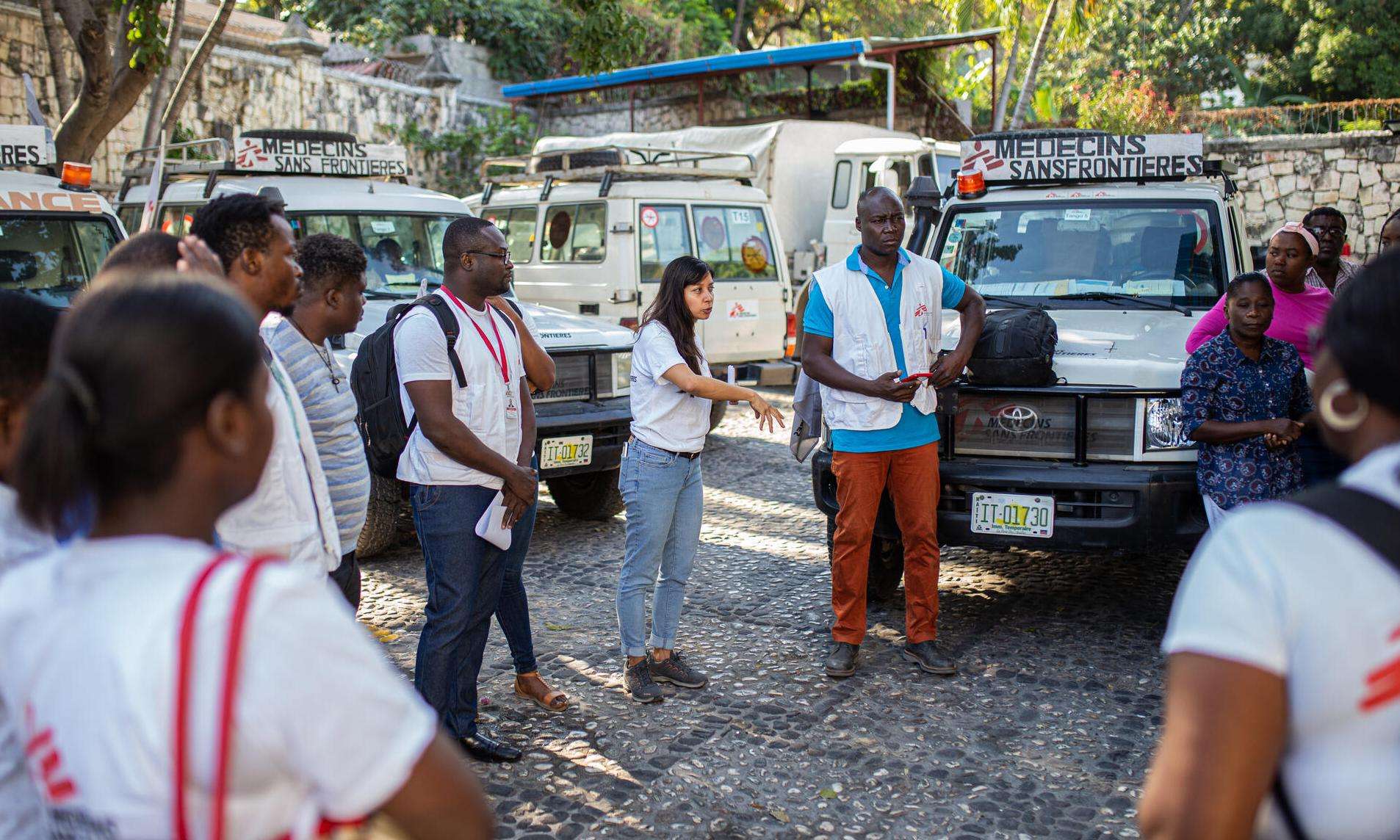 MSF staff stand in a circle at the mobile clinic in Bel Air, Haiti