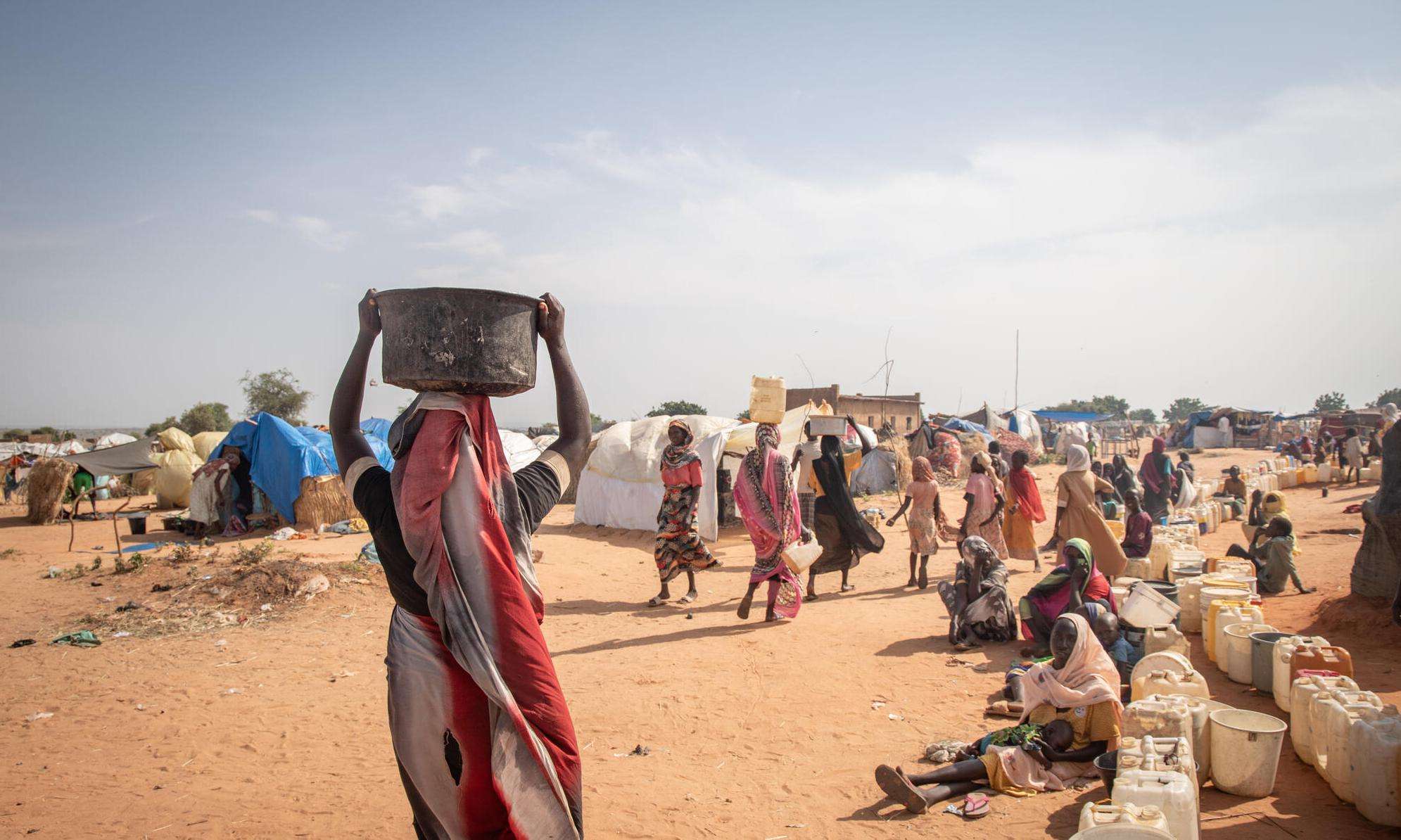 Sudanese refugees fetch water in a refugee camp in Chad.