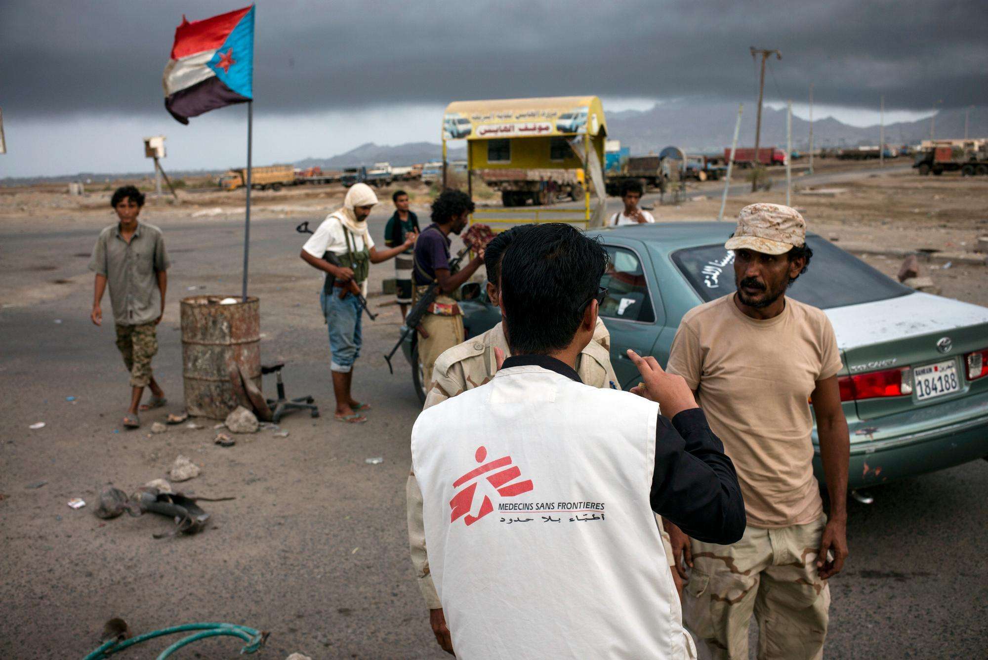 MSF staff speaking with armed men at a check point
