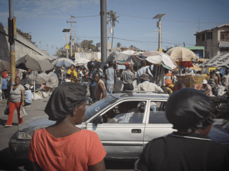 A busy scene with people in the middle of Port-au-Prince