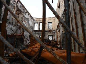The scaffolding of a heavily destroyed building in Ukraine.