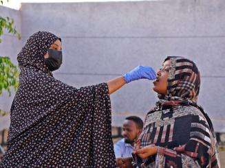 A woman administers a cholera oral vaccine in Ethiopia.