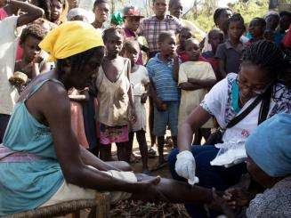 Cassandre Saint-Hubert MSF nurse (from Haiti) treats a patient at a Medecins Sans Frontieres (MSF) mobile clinic in the village of Nan Sevre, in the mountains north of Port-à-Piment.