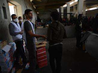 MSF teams conduct a food distribution in a detention center in Libya.