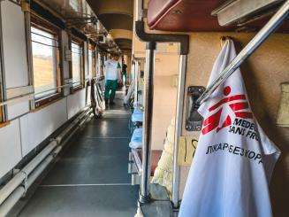 White cloth with MSF logo hangs inside the MSF medical evacuation train in Ukraine.