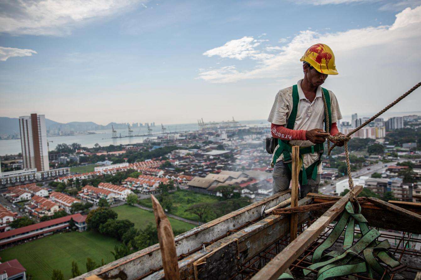 A Rohingya worker works on a construction site in Penang, Malaysia.