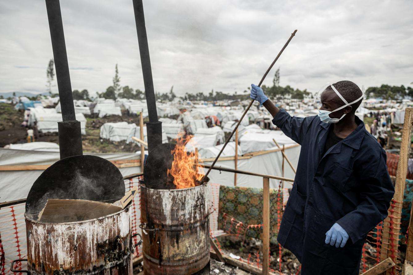 An internally displaced person burns items infected by cholera in a camp in Democratic Republic of Congo.