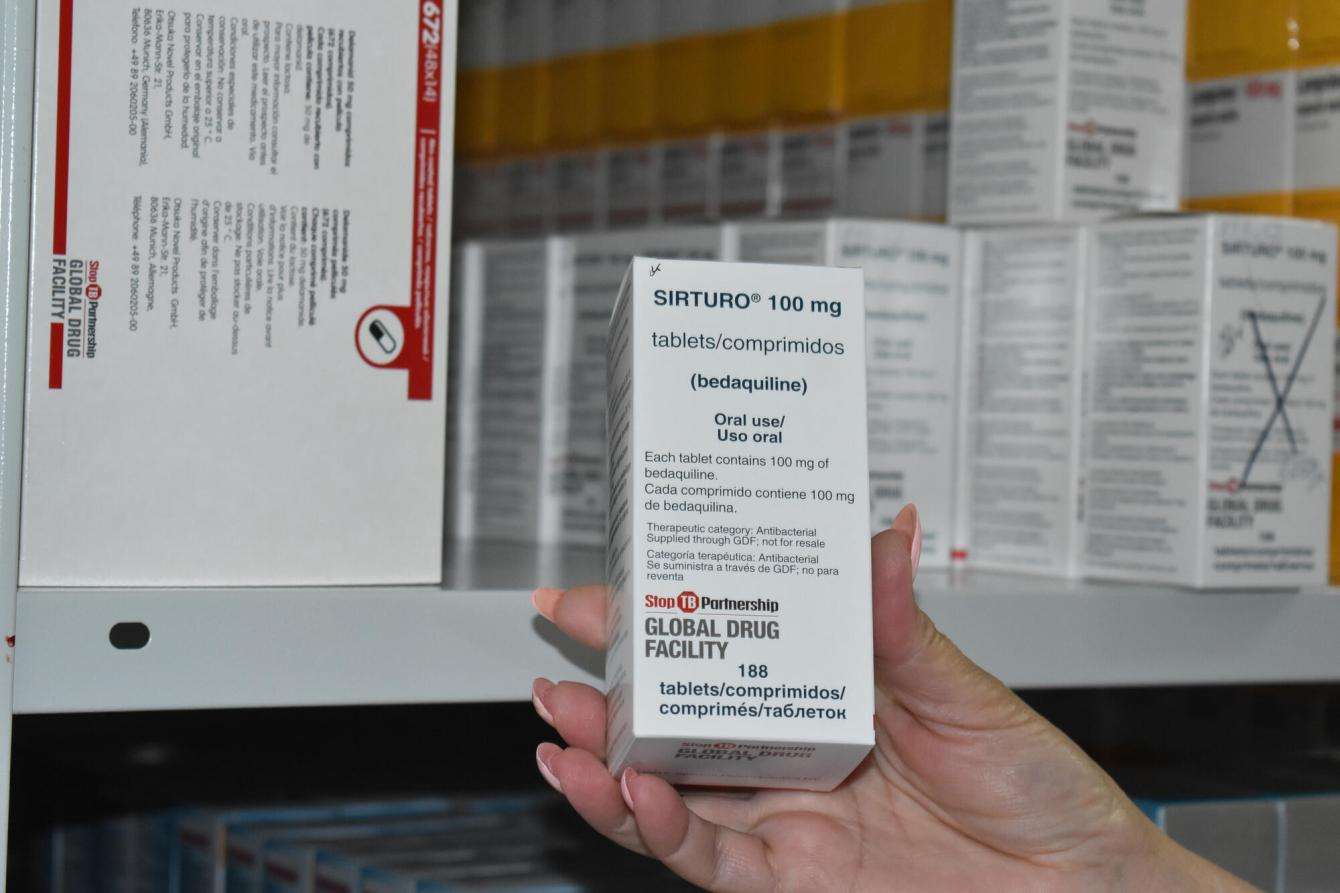 A hand holds up a box of Bedaquiline in an MSF medical facility in Minsk, Belarus.