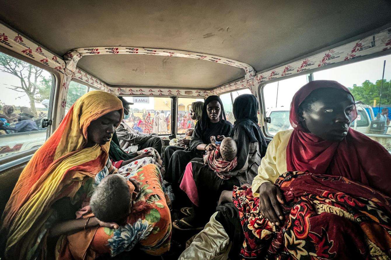 Sudanese refugee women arrive at Adré hospital in Chad on a bus.