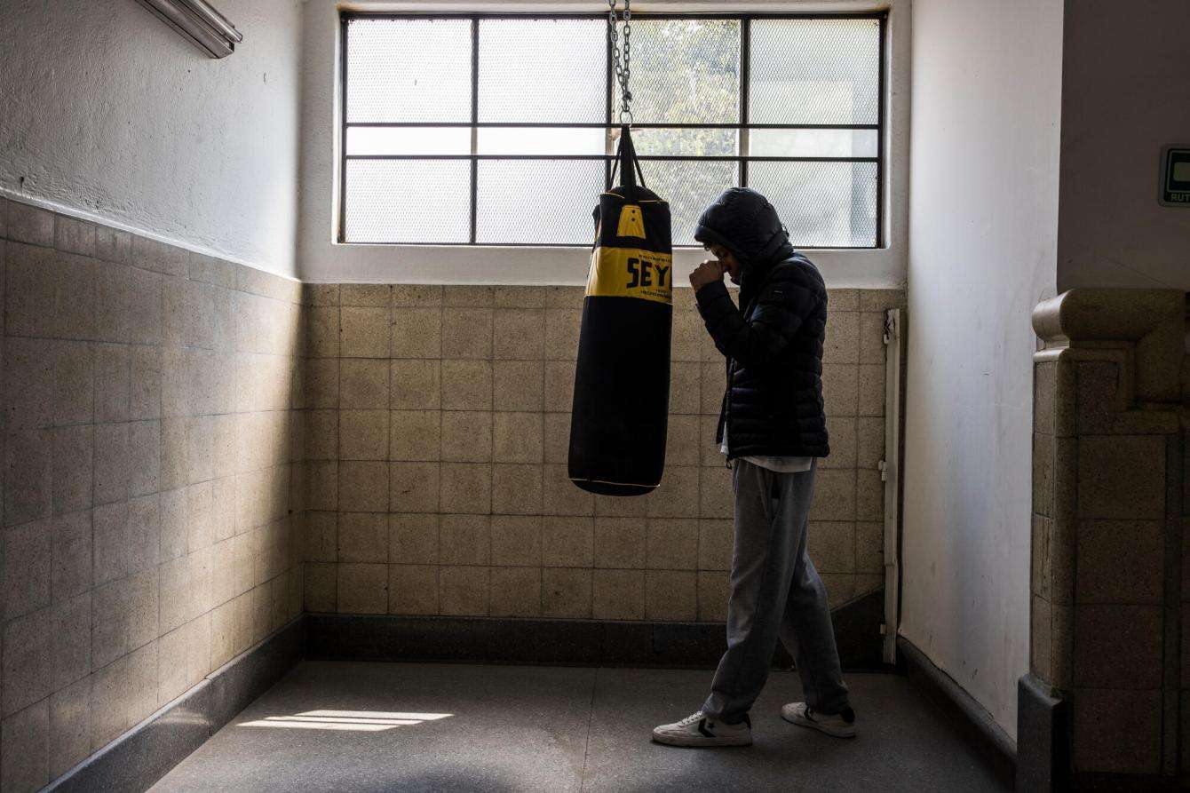 A man boxes in a room in Mexico.