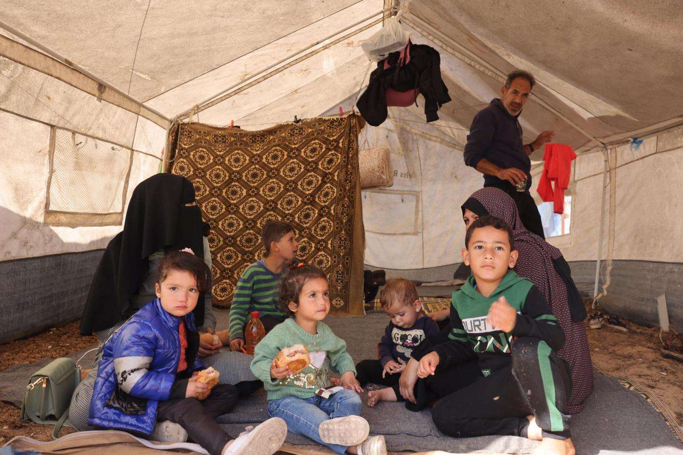 Displaced Palestinian children in a tent in southern Gaza.