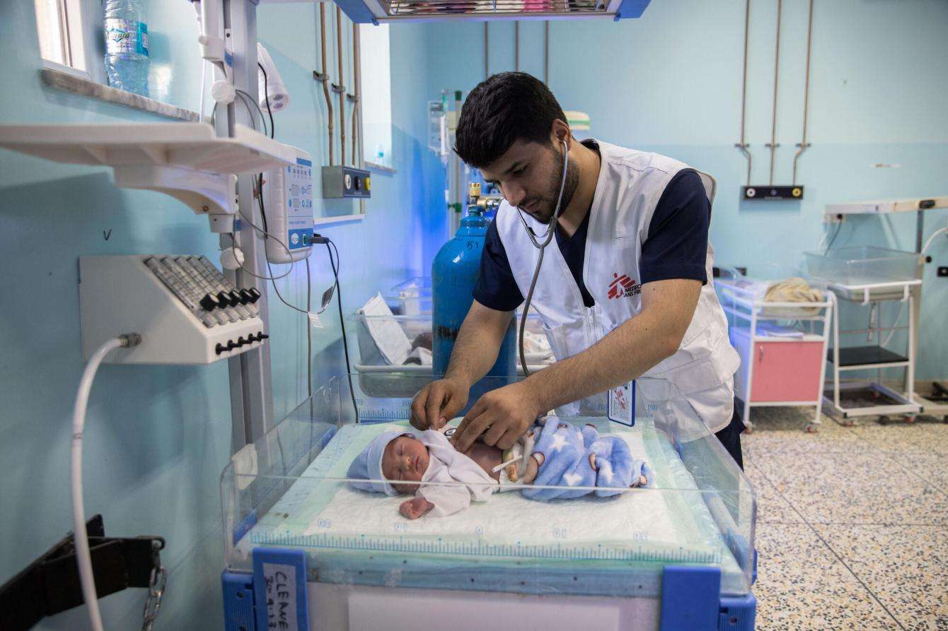 An MSF doctor checks on a child patient at the NICU MSF supports at Mazar-i-Sharif Regional Hospital in Afghanistan.