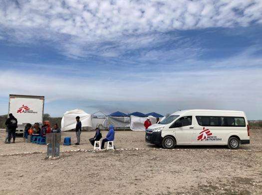 White MSF vehicles in the desert at the US-Mexico border.