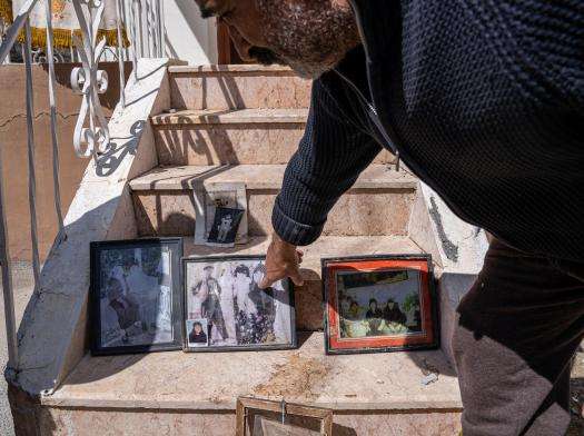 A displaced family in Turkey looks at family photos salvaged from their home after it was destroyed in the earthquake.