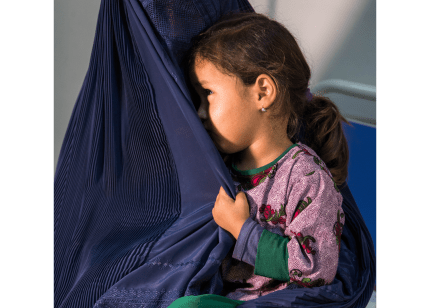 An Afghan child clutches her mother's veil at Mazar-i-Sharif Regional Hospital in Balkh province, Afghanistan.