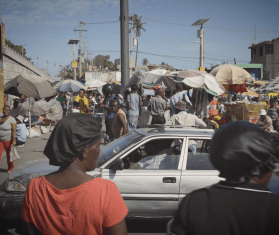 A busy scene with people in the middle of Port-au-Prince