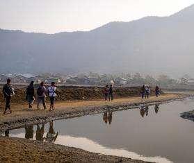 MSF staff on their journey to set up a clinic next to a river.