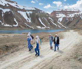 Girls walk to school with mountains of Bamyan province, Afghanistan in the background.