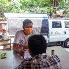 A patient living with HIV and hepatitis C speaks with an MSF health worker in Yangon.
